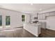 Bright, open kitchen with island, granite countertops, stainless steel appliances, and ample cabinet space at 1483 Autumn Wind Dr # 24, Dacula, GA 30019