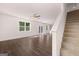 Bright living room with hardwood floors, ceiling fan, and staircase at 1483 Autumn Wind Dr # 24, Dacula, GA 30019