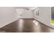 Living room featuring hardwood floors, natural light, recessed lighting, and backyard access at 1483 Autumn Wind Dr # 24, Dacula, GA 30019