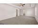 Spacious bedroom featuring neutral carpet, ceiling fan and ensuite bathroom entrance at 1483 Autumn Wind Dr # 24, Dacula, GA 30019