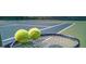 Close-up of tennis balls on a racket on a well-maintained court, perfect for active residents at 1483 Autumn Wind Dr # 24, Dacula, GA 30019