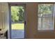 View of the rear patio and yard through a glass panel back door and large window at 2700 Marlin Dr, Mcdonough, GA 30253