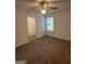 Bedroom with ceiling fan, window, and carpeted floor next to a bathroom at 2700 Marlin Dr, Mcdonough, GA 30253