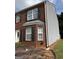 Brick townhome with vinyl siding on the side, and a small strip of grass at 2700 Marlin Dr, Mcdonough, GA 30253