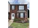 Charming brick townhome featuring black shutters, a bay window, and a well-manicured front lawn at 2700 Marlin Dr, Mcdonough, GA 30253