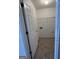 Bright laundry room with tile flooring and shelving ready for appliances at 2700 Marlin Dr, Mcdonough, GA 30253