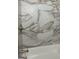 Close-up of bathroom tub and shower showcasing gorgeous marble-patterned tiling at 2953 Meadowview Se Dr, Atlanta, GA 30316