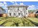 Large backyard featuring a well-maintained lawn, privacy fence, and patio at 1511 Arica Ave, Lawrenceville, GA 30043