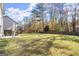 Expansive backyard featuring a lawn, tall privacy fence, and mature trees at 1511 Arica Ave, Lawrenceville, GA 30043
