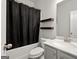 Clean bathroom features a shower-tub combo and floating shelves at 1511 Arica Ave, Lawrenceville, GA 30043