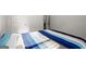 Bedroom with blue striped bed cover, carpet, and white walls at 1511 Arica Ave, Lawrenceville, GA 30043