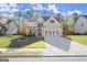 Inviting two-story home with brick accents, well-kept lawn, and concrete driveway at 1511 Arica Ave, Lawrenceville, GA 30043