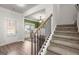 Welcoming foyer with staircase, wood floors, and a view into the dining room at 1511 Arica Ave, Lawrenceville, GA 30043