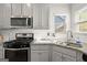 Bright kitchen featuring stainless steel appliances, granite countertops, and subway tile backsplash at 1511 Arica Ave, Lawrenceville, GA 30043