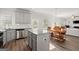 Open-concept kitchen with granite counters, stainless appliances, and a view of the dining and living areas at 1511 Arica Ave, Lawrenceville, GA 30043