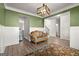 Cozy living room with hardwood floors, accent walls, and decorative light fixture at 1511 Arica Ave, Lawrenceville, GA 30043