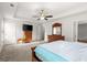 Bright main bedroom with carpet, ceiling fan and views into another room at 1511 Arica Ave, Lawrenceville, GA 30043