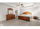 Spacious main bedroom with wood furniture, ceiling fan, and light-colored walls at 1511 Arica Ave, Lawrenceville, GA 30043