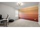 Bright office space with a horizontally striped accent wall and modern desk at 1511 Arica Ave, Lawrenceville, GA 30043
