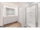 Bathroom showcasing a glass-enclosed shower, double sink vanity with white cabinets, and wood-look floors at 7222 Lacey Dr. # 127, Douglasville, GA 30134