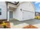 Charming exterior showcasing a two-car garage and well-maintained landscaping at 7222 Lacey Dr. # 127, Douglasville, GA 30134