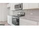 Modern kitchen featuring stainless steel appliances, granite countertops, and white cabinets at 7222 Lacey Dr. # 127, Douglasville, GA 30134