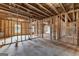 Unfinished basement shows framed walls, insulation, and concrete floor with window at 130 Windchime Way # 9, Tyrone, GA 30290