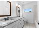 Bathroom view with granite counters, white cabinets, framed mirrors, tile floor, and shower-tub combo at 130 Windchime Way # 9, Tyrone, GA 30290