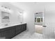 Bathroom with dual vanities, gray cabinets, and marble floors adjacent to the bedroom at 130 Windchime Way # 9, Tyrone, GA 30290
