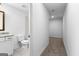 Bathroom with white vanity, granite counters, toilet, and hallway access at 130 Windchime Way # 9, Tyrone, GA 30290