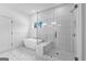 Stylish bathroom featuring a modern soaking tub, glass shower, and bright window view at 130 Windchime Way # 9, Tyrone, GA 30290
