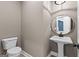 Updated powder room with a pedestal sink, modern mirror, and updated fixtures at 130 Windchime Way # 9, Tyrone, GA 30290