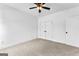Spacious bedroom with a ceiling fan, carpet, closet and white paint at 130 Windchime Way # 9, Tyrone, GA 30290