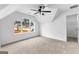 Bright bedroom with large windows, ceiling fan, neutral carpet, and walk-in closet at 130 Windchime Way # 9, Tyrone, GA 30290