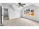 Bright bedroom featuring a ceiling fan and large windows with a view of the outdoors at 130 Windchime Way # 9, Tyrone, GA 30290