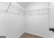 Walk-in closet featuring white wire shelving and neutral carpeting at 130 Windchime Way # 9, Tyrone, GA 30290