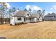 View of the home highlighting the architectural details and front yard at 130 Windchime Way # 9, Tyrone, GA 30290