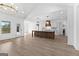 Open kitchen with stainless appliances, custom island, breakfast bar, and wood-look flooring at 130 Windchime Way # 9, Tyrone, GA 30290