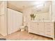 Bright bathroom with white vanity, decorative mirror, and shower with white curtain at 3435 Vista Creek Dr, Dacula, GA 30019