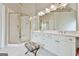 Bathroom features a walk-in shower with glass door and large vanity with dual sinks and white cabinets at 3435 Vista Creek Dr, Dacula, GA 30019