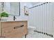Charming bathroom featuring wood vanity, shiplap walls, and modern black and white decor at 3435 Vista Creek Dr, Dacula, GA 30019