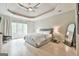 Spacious bedroom with trey ceiling, large window with natural light, and light hardwood floors at 3435 Vista Creek Dr, Dacula, GA 30019