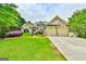 Charming home with a well-manicured lawn, stone accents, and a spacious three-car garage at 3435 Vista Creek Dr, Dacula, GA 30019