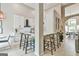 Bright kitchen featuring white cabinets, black hardware, modern appliances, and an eat-in bar area at 3435 Vista Creek Dr, Dacula, GA 30019