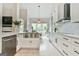 Bright kitchen featuring a stainless steel sink, white cabinets, modern appliances, and hardwood floors at 3435 Vista Creek Dr, Dacula, GA 30019