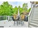 Outdoor patio featuring comfortable seating, an umbrella for shade, and lush green trees at 3435 Vista Creek Dr, Dacula, GA 30019