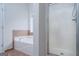 Bathroom featuring a tile-surround tub and a glass-enclosed shower with modern fixtures at 1870 Wildcat Trace Cir, Lawrenceville, GA 30043