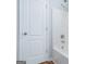 Bathroom features a white door, a showerhead, and a bathtub with white tile surround at 1870 Wildcat Trace Cir, Lawrenceville, GA 30043