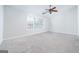 Bright bedroom features neutral carpet, a ceiling fan, and a window letting in natural light at 1870 Wildcat Trace Cir, Lawrenceville, GA 30043