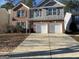 Charming two-story home with a brick and gray shingle exterior and a spacious two-car garage at 1870 Wildcat Trace Cir, Lawrenceville, GA 30043